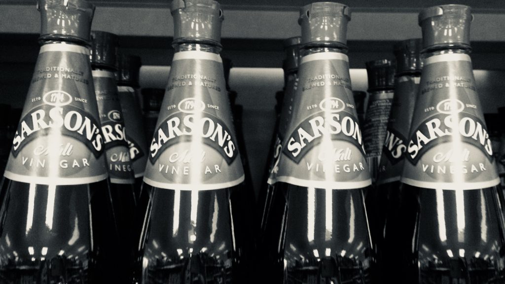 Black and white picture of 4 bottles of parsons vinegar