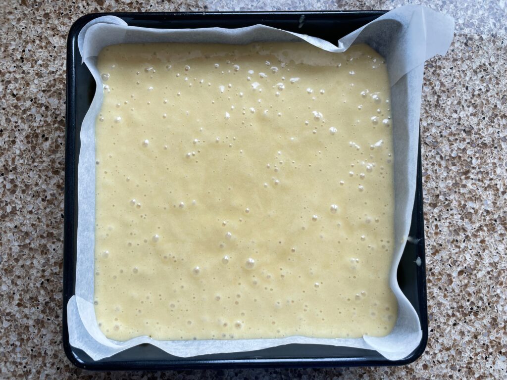 Gluten free ginger sponge mixture in a baking tin