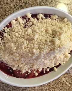 Gluten free plum crumble prior to baking without sugar on top