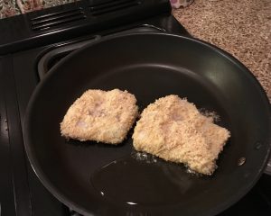 gluten free breaded fish in a frying pan