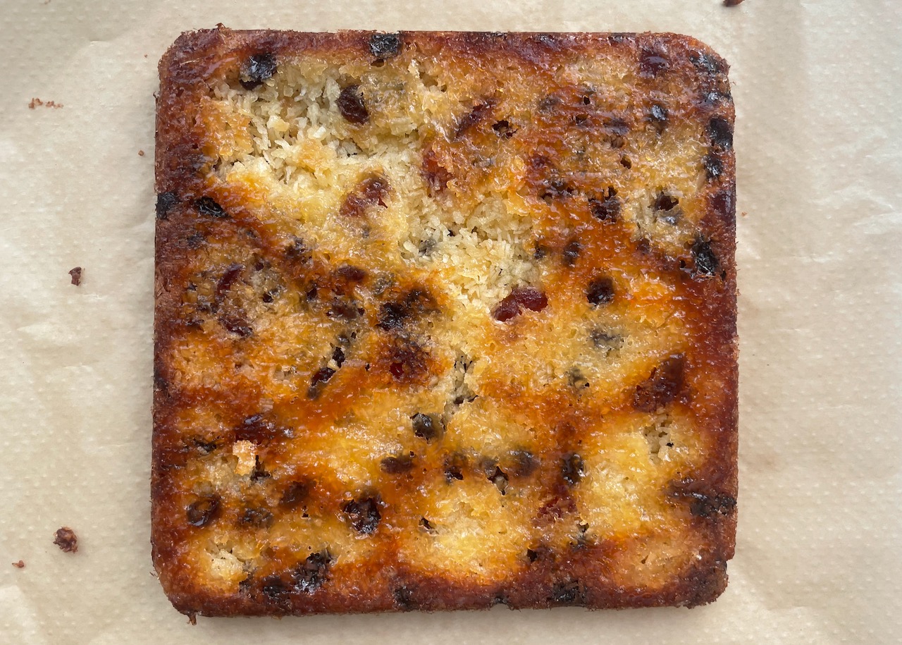 Baked chocolate picnic slice, upside down on greaseproof paper. 
