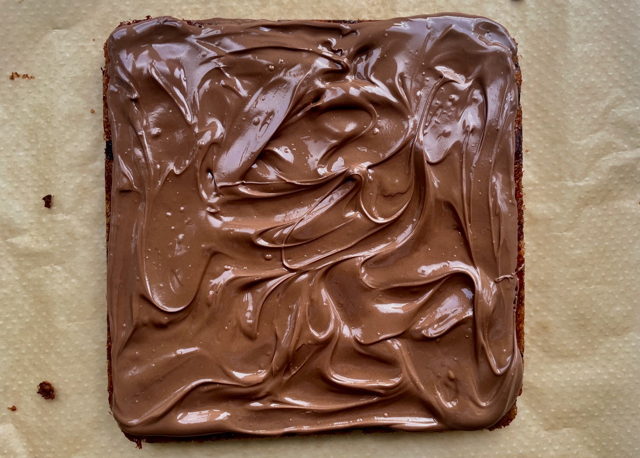 Melted chocolate spread over chocolate picnic slice