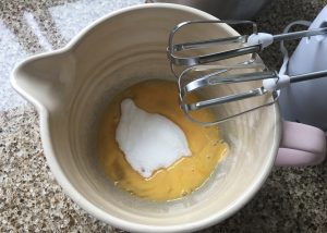 Eggs and sugar in a bowl - base for a gluten free Swiss roll