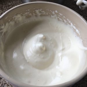 Whipped Eggs and sugar in a bowl - base for a gluten free Swiss roll