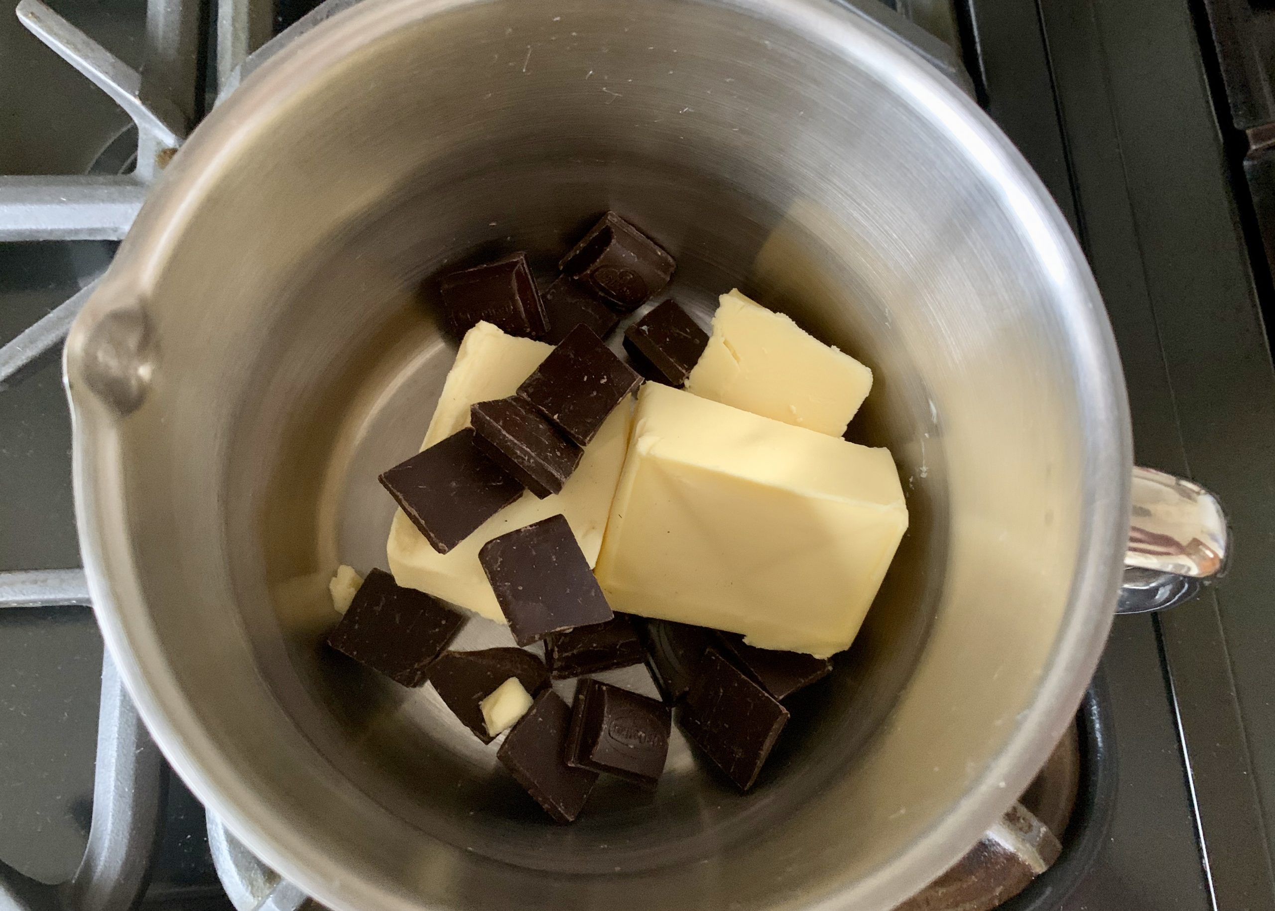 Butter and dark chocolate in a pan. for gluten free Black Forest gateau