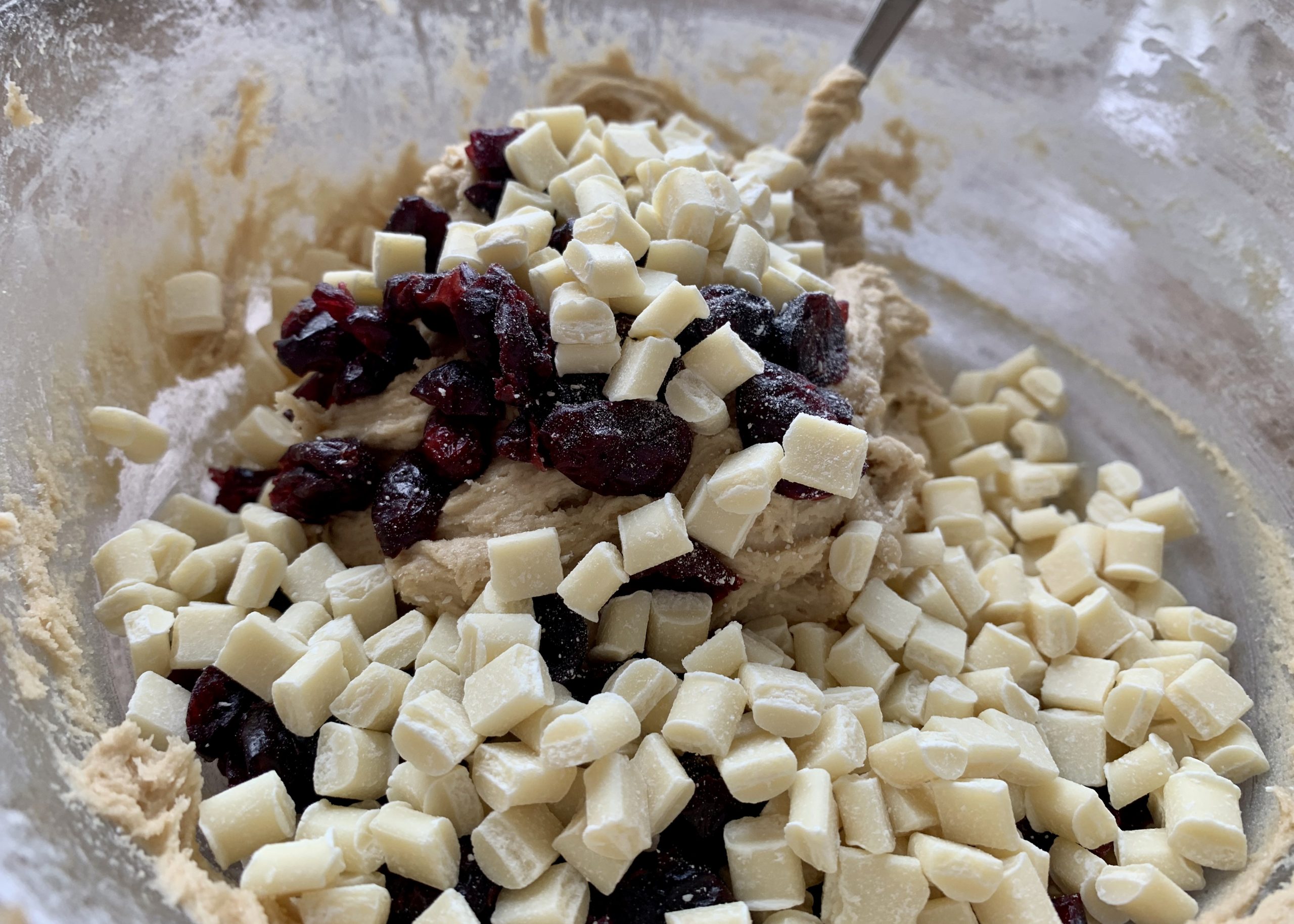 Gluten free cookie dough mixture with white chocolate chunks and cranberries added