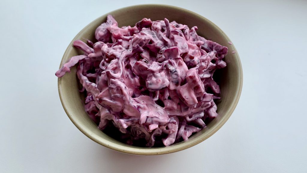 A dish filled with homemade red slaw