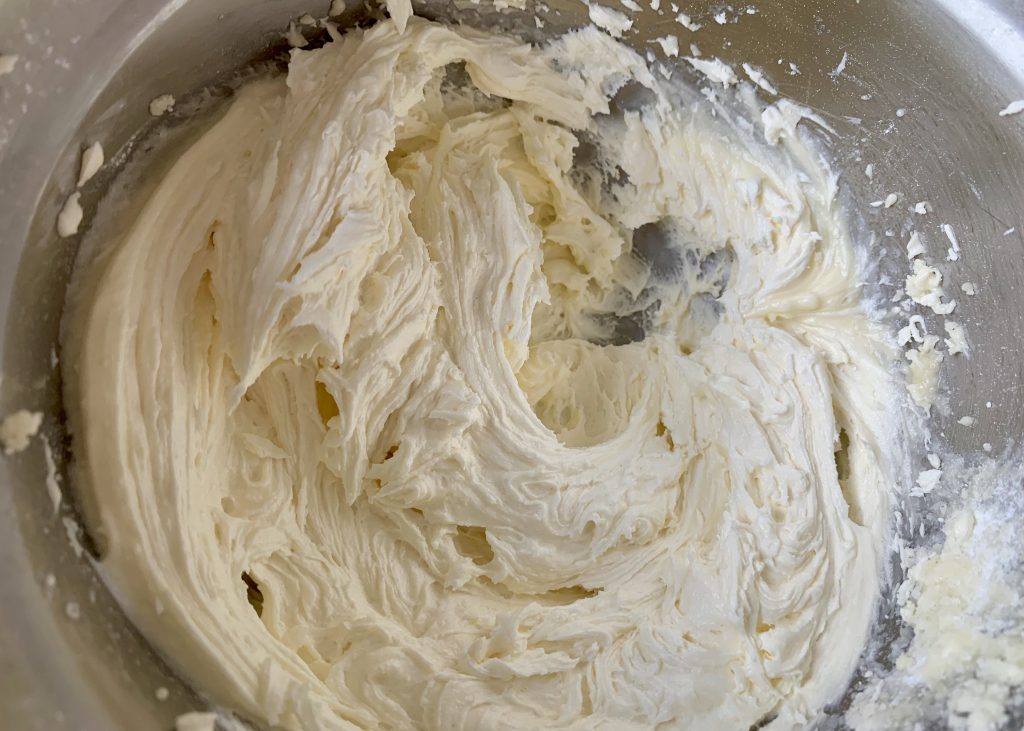 Freshly whipped buttercream in a large mixing bowl