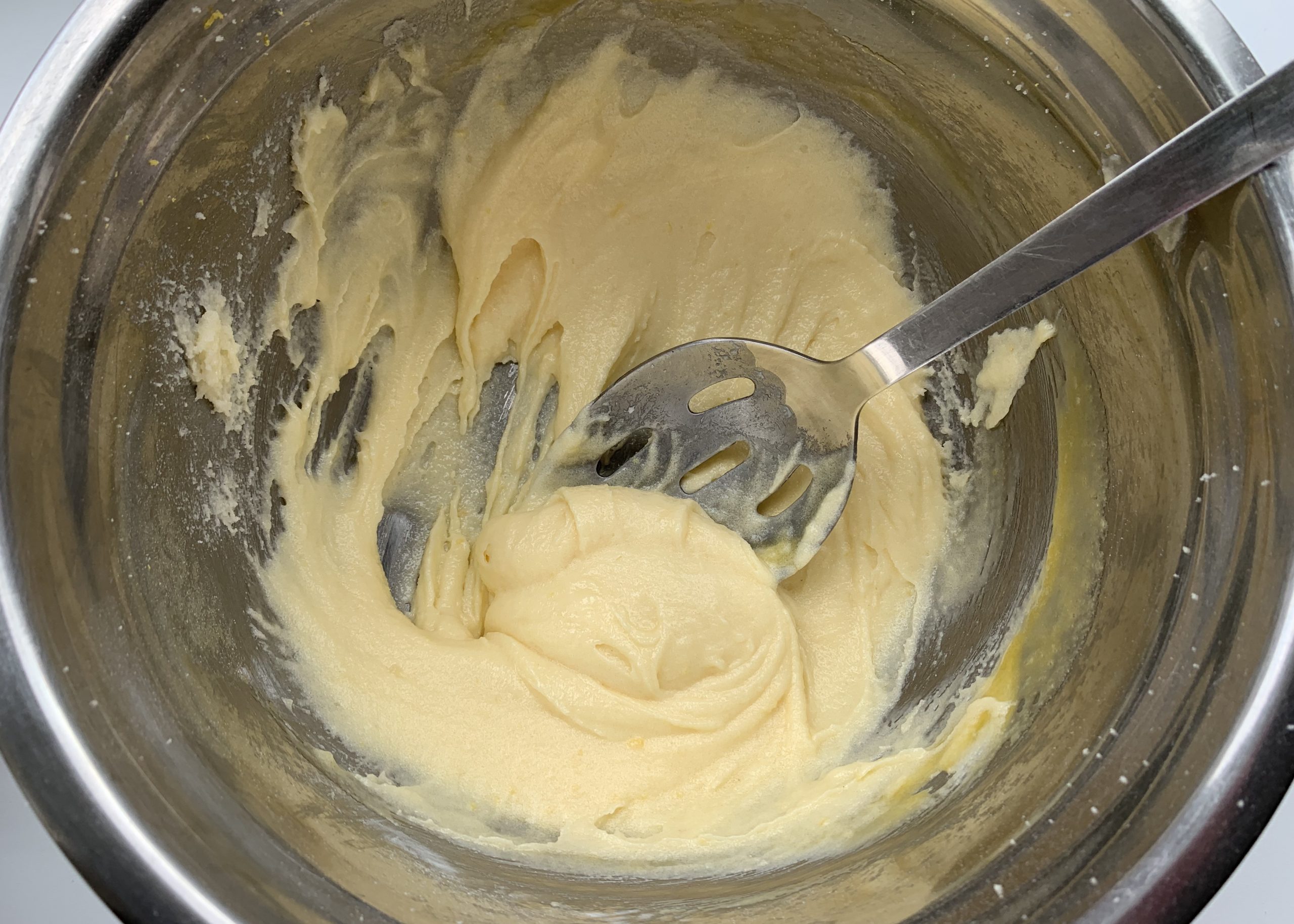 Mixture in a stainless steel bowl for gluten free lemon surprise pudding