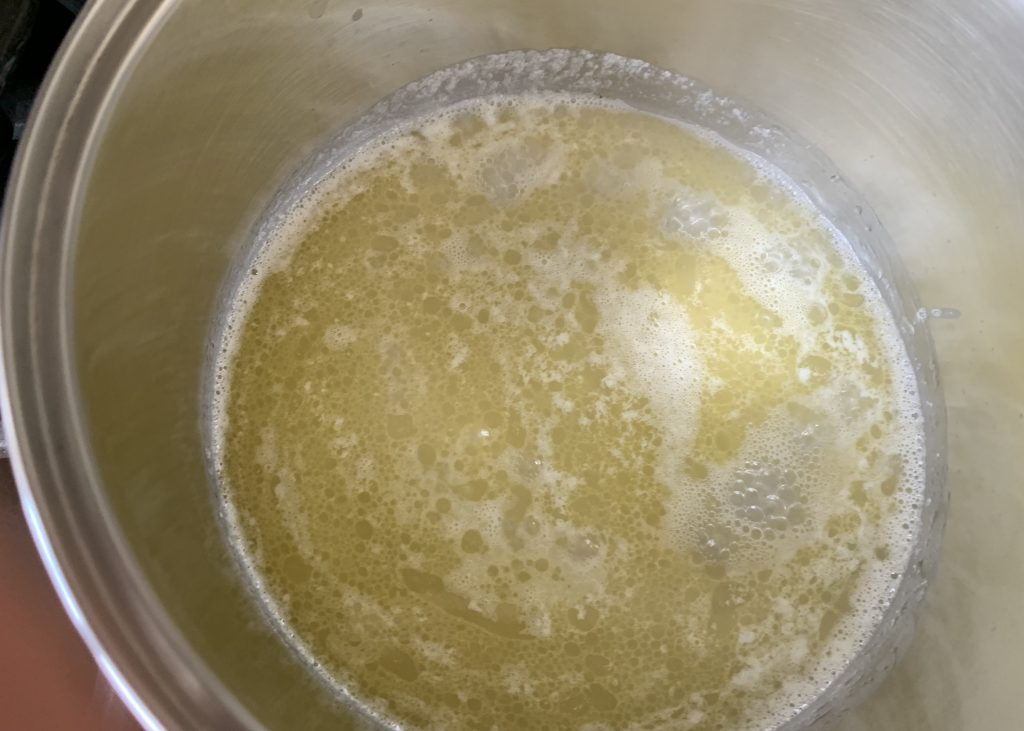 Butter melted in water in a pan