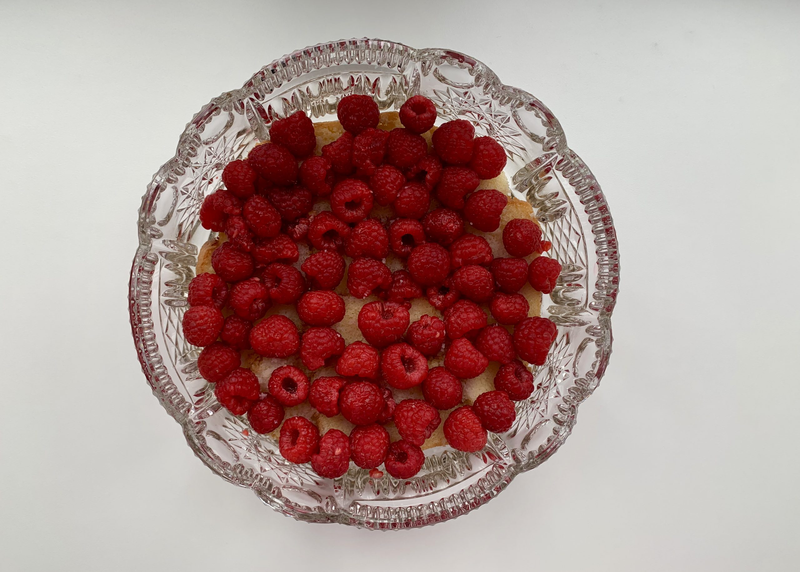 Gluten free sponge with raspberries in a glass bowl