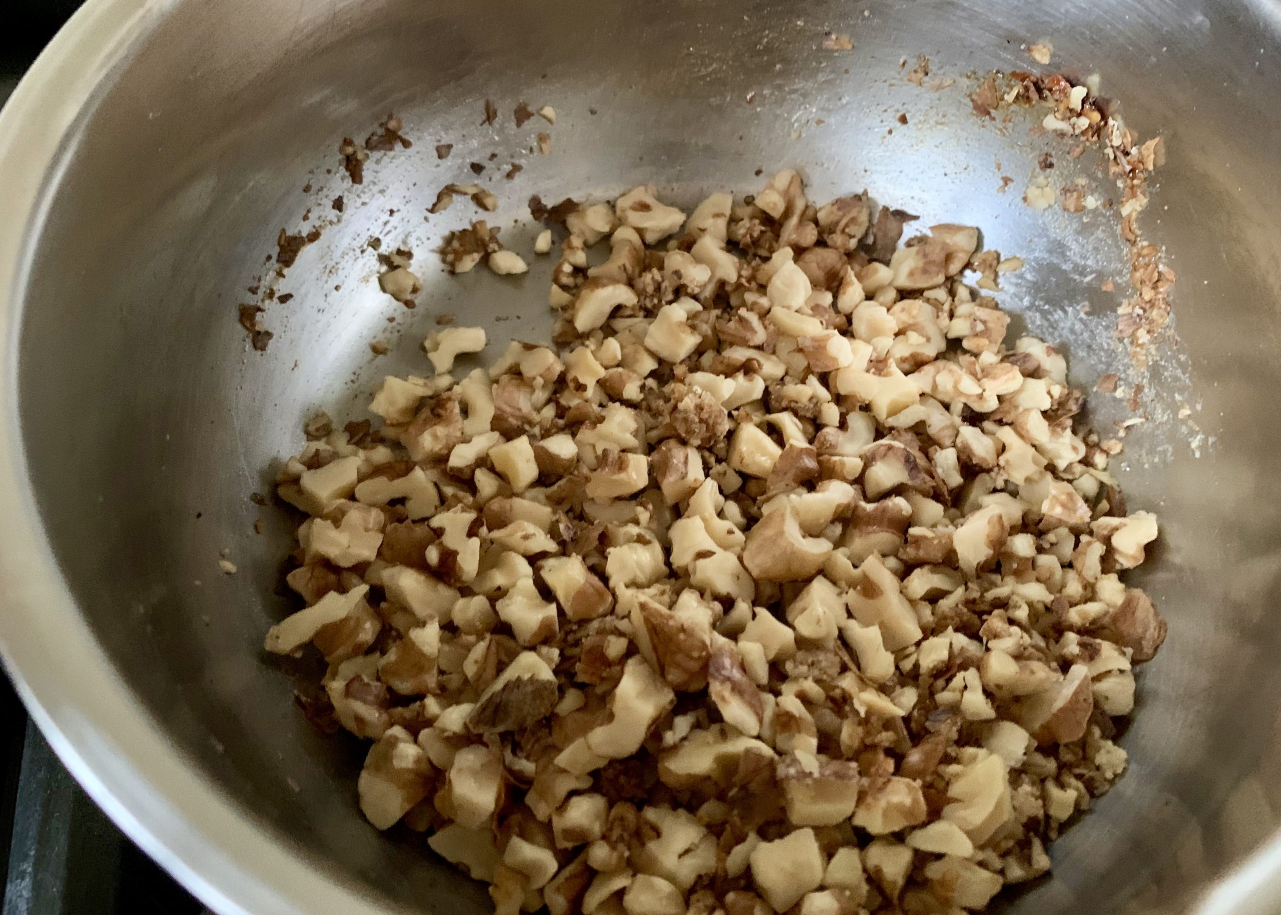 Chopped walnuts with sugar in a pan