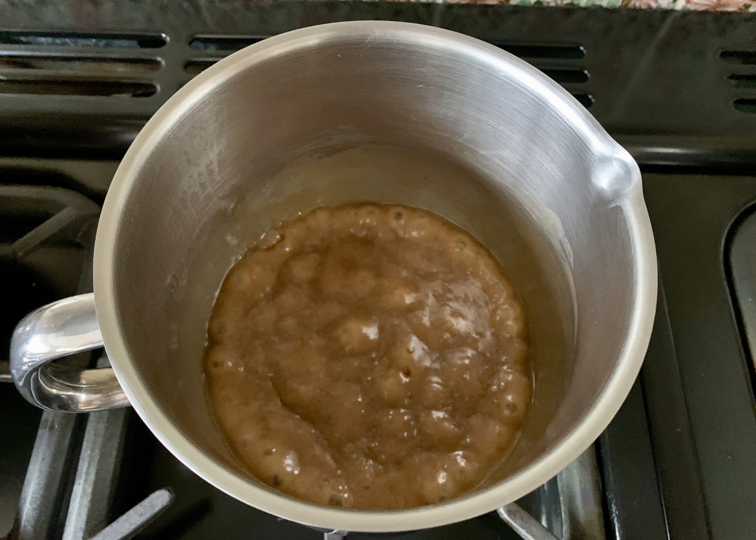 Sticky toffee sauce in a saucepan