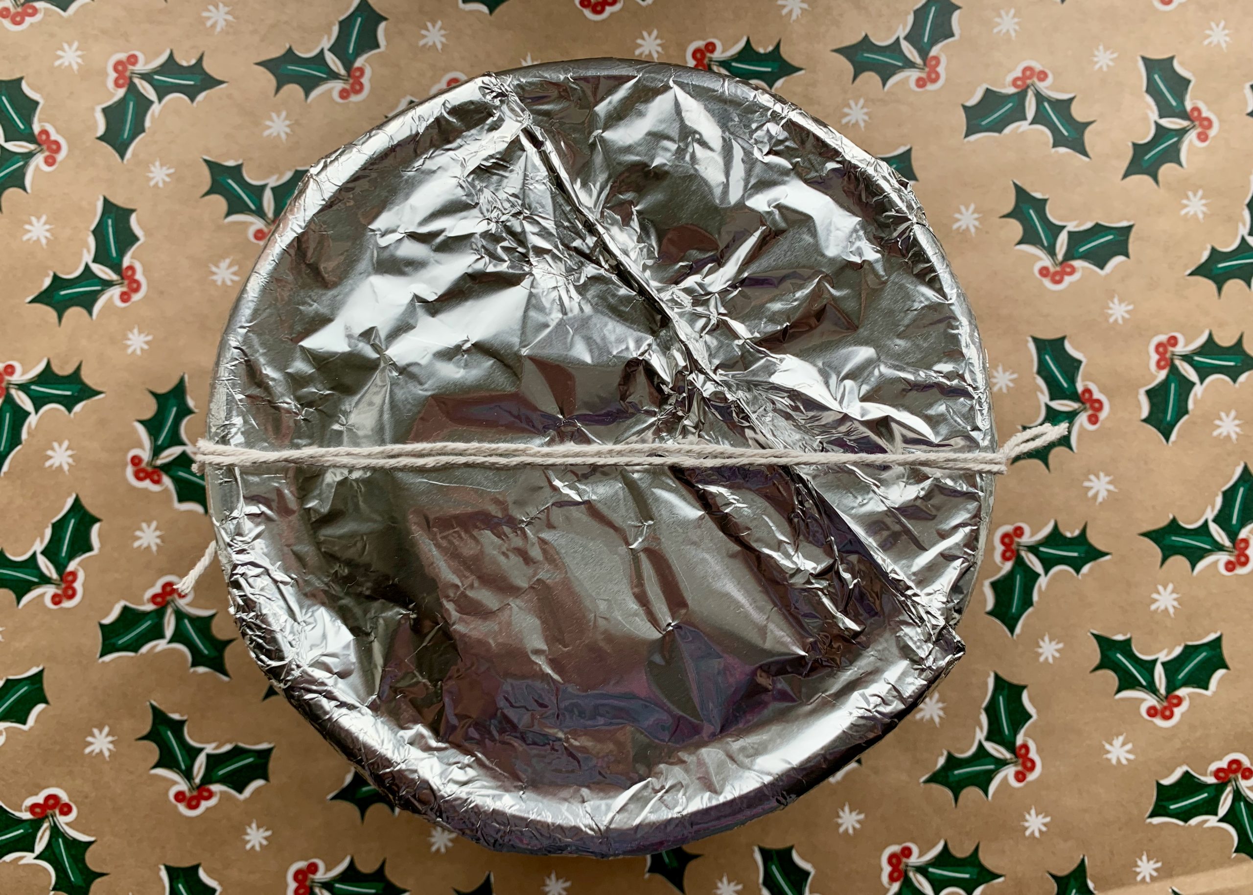 Gluten free Christmas pudding covered with foil and ready to be steamed