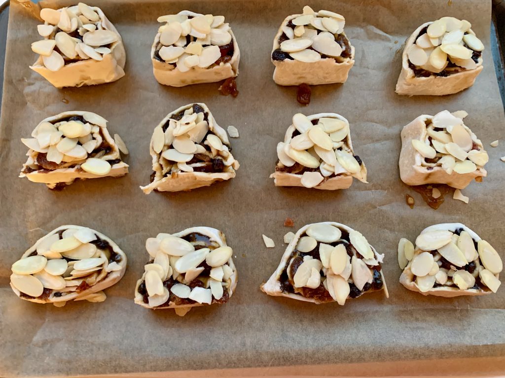 Gluten free mincemeat, cherry and almond swirls on a baking tray before being baked