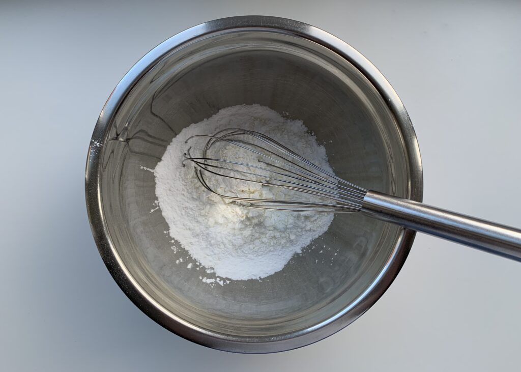 Gluten free flour, xanthan gum, cornflour and icing sugar in a stainless steel bowl