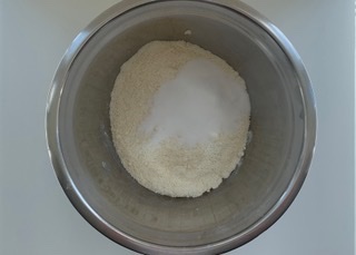 Dry gluten free scone mixture in a stainless steel bowl