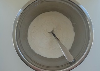 Gluten free flour, xanthan gum and baking powder in a stainless steel bowl