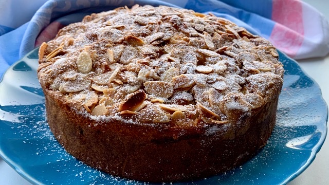 Freshly baked pear cake on a blue plate