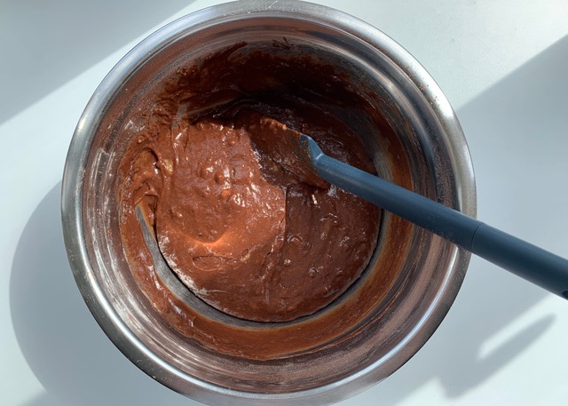 Mixture for gluten free chocolate banana bread in a stainless steel bowl