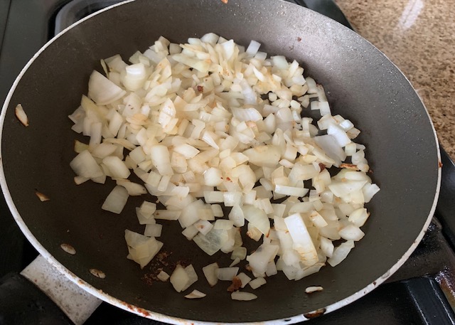 Diced onions in a frying pan