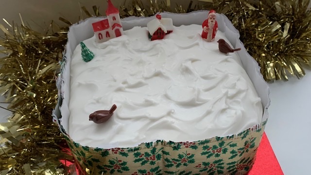 Gluten free Christmas cake with decorative ruffle around the sides