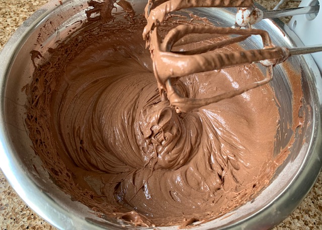 Gluten free chocolate cake mixture in a stainless steel bowl