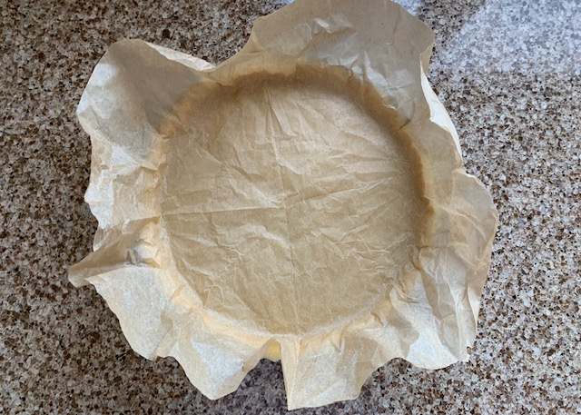 Sweet pastry flan base lined with baking paper