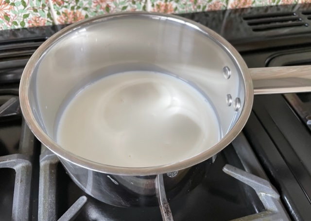 Hot milk and sugar in a stainless steel pan