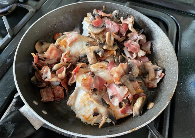 Chicken. bacon and mushrooms in a pan
