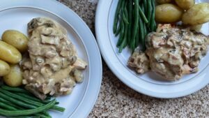 Chicken Jean Bart on a plate with new potatoes and green beans