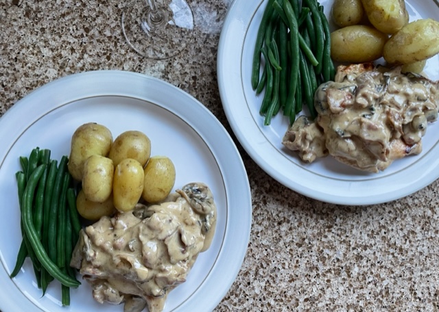 Chicken Jean Bart on a plate with new potatoes and green beans
