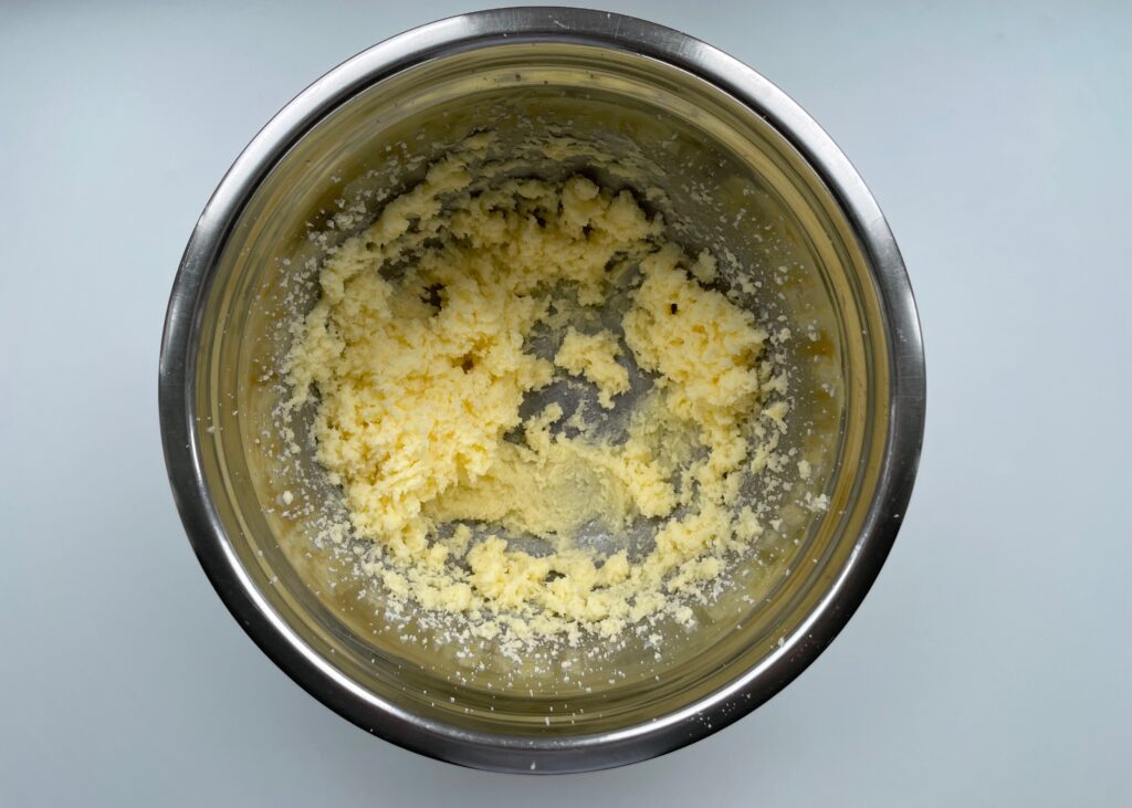 Blended butter and sugar in a stainless steel mixing bowl