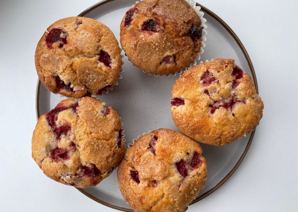 5 gluten free strawberry muffins on a round plate