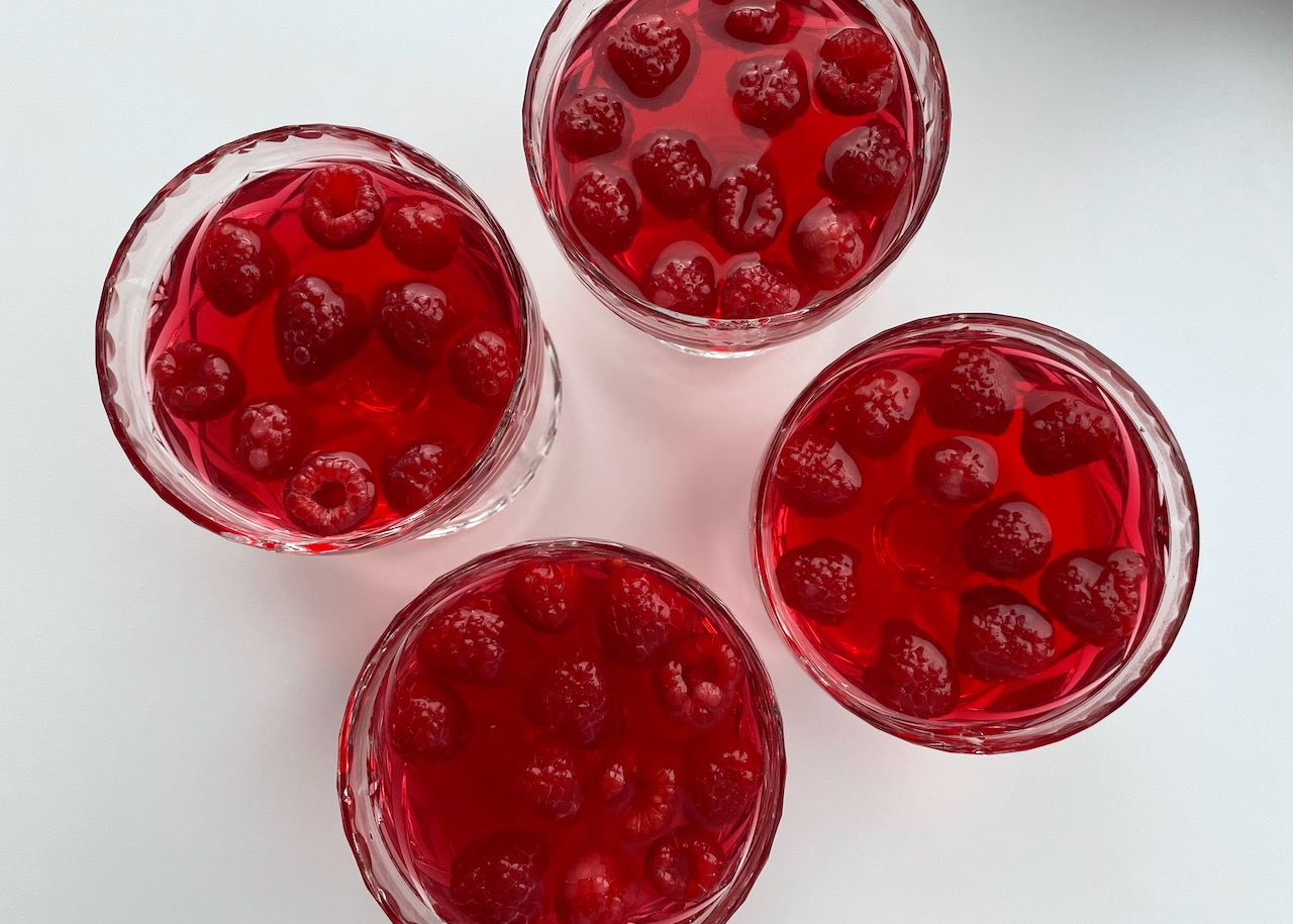 Raspberries in jelly in four glass dishes