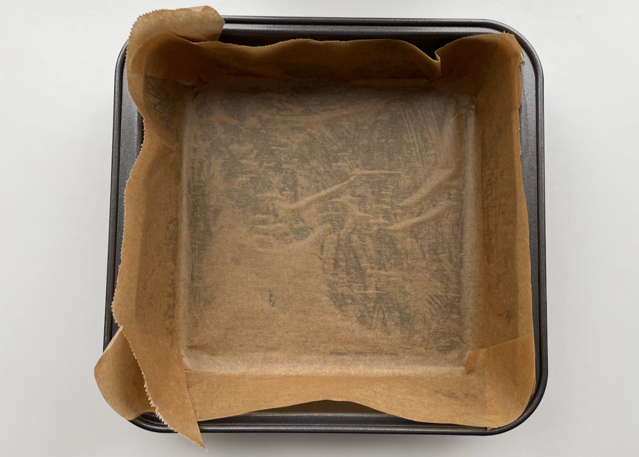 Greased and lined 7 inch square tin