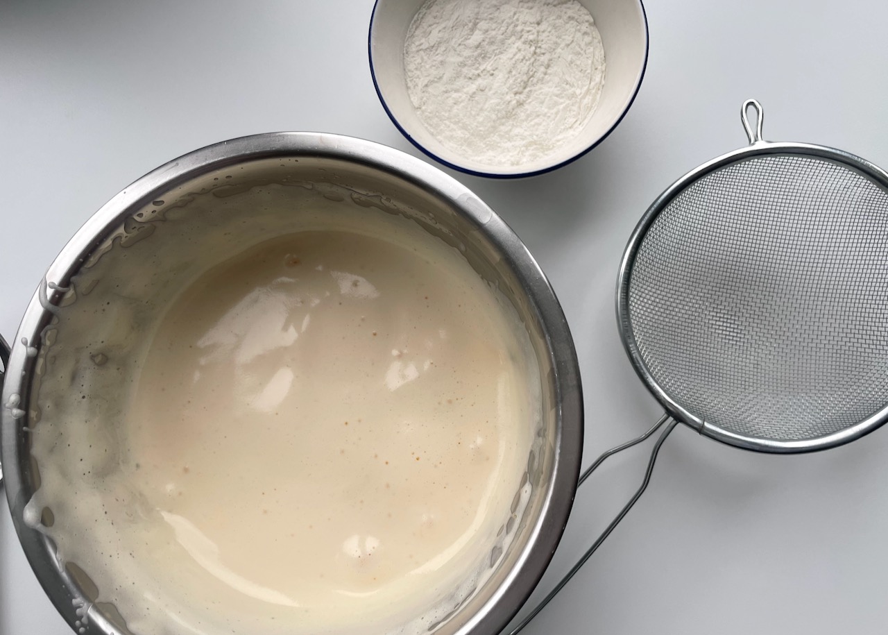 Whisked eggs and sugar in a stainless steel bowl