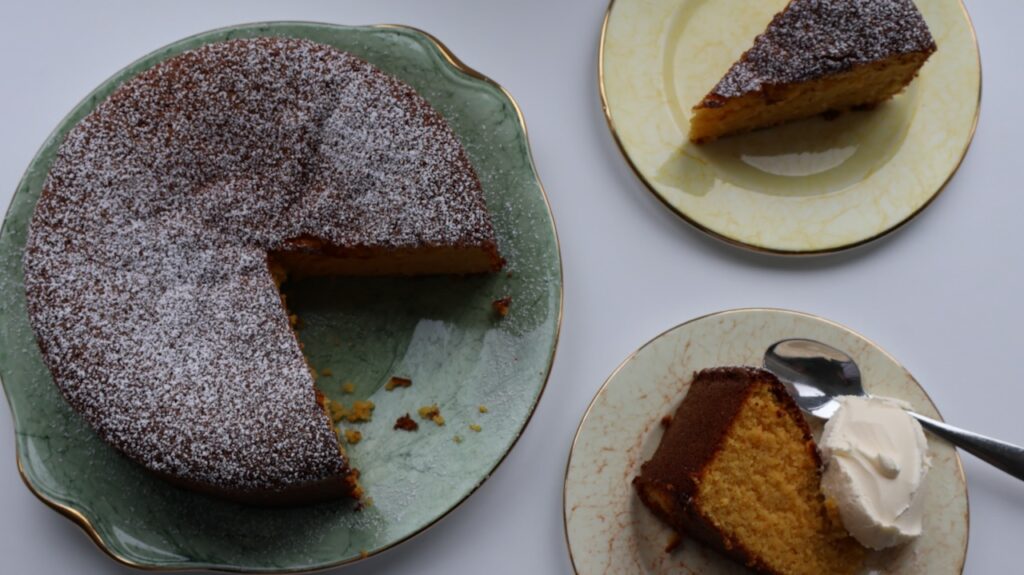 Boiled clementine cake portioned on a plate.