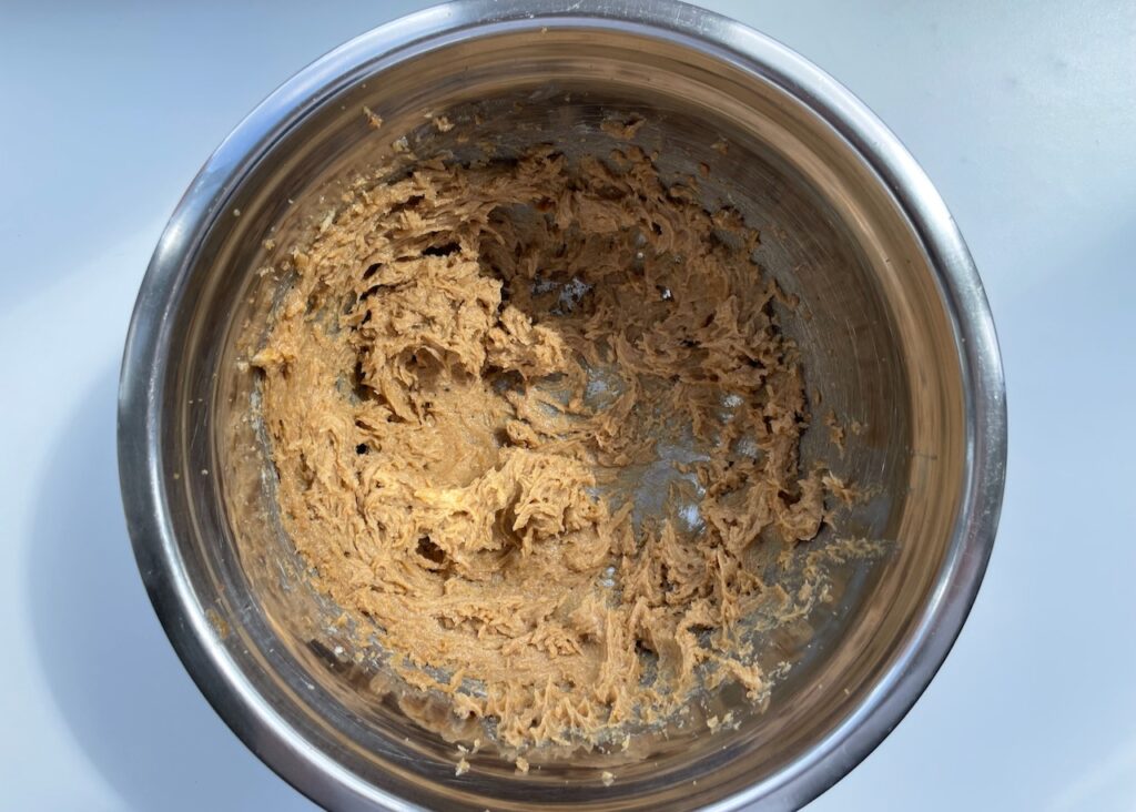 Butter and brown sugar creamed together in a stainless steel bowl